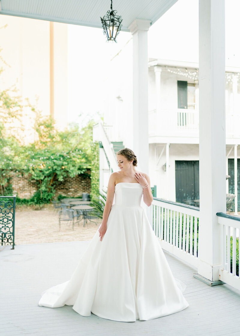 bride standing on a porch at the Ezell House