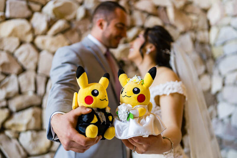 Close-up of two small Pikachu figures dressed as a bride and groom during a Pokémon-themed Colorado wedding.