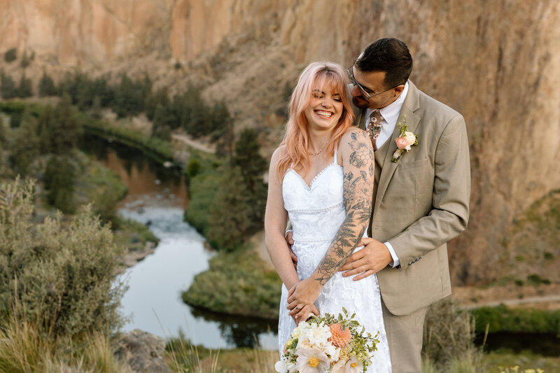 Bride and groom embracing at Smith Rock State Park.