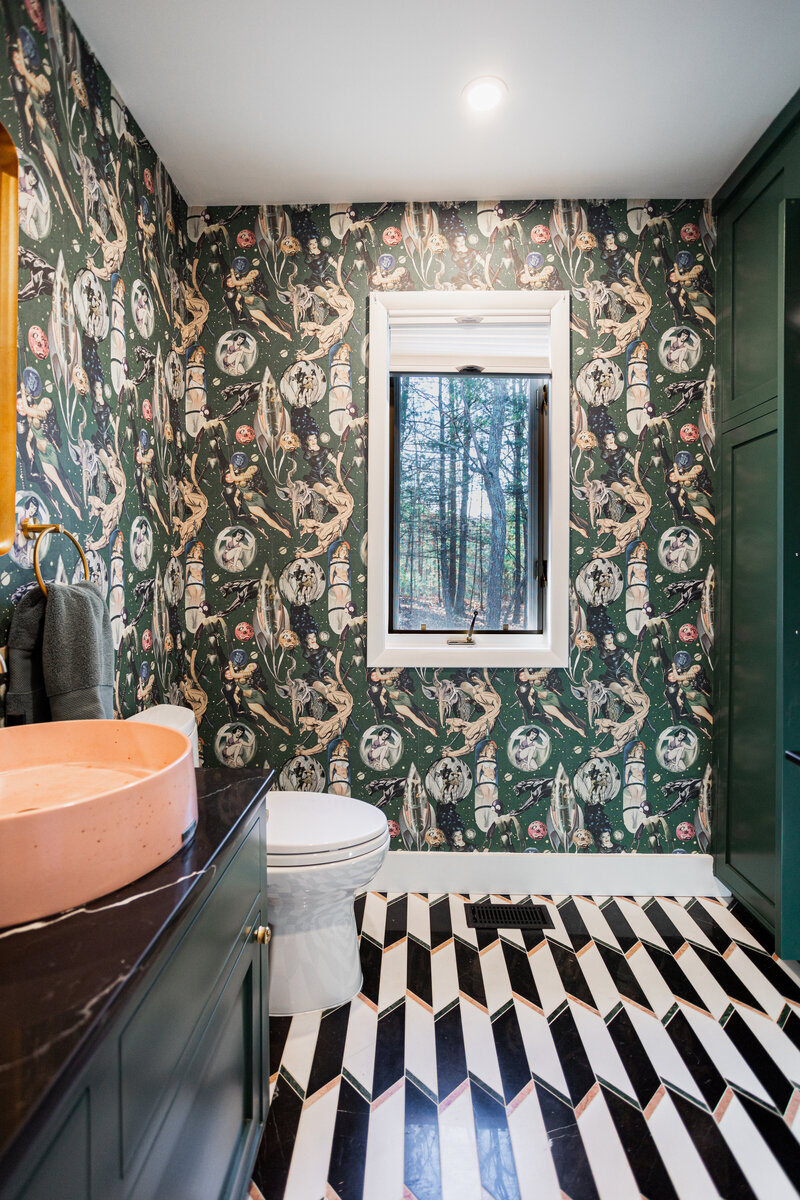 Stylish bathroom with dark floral wallpaper, black and white checkered floor, and a small window