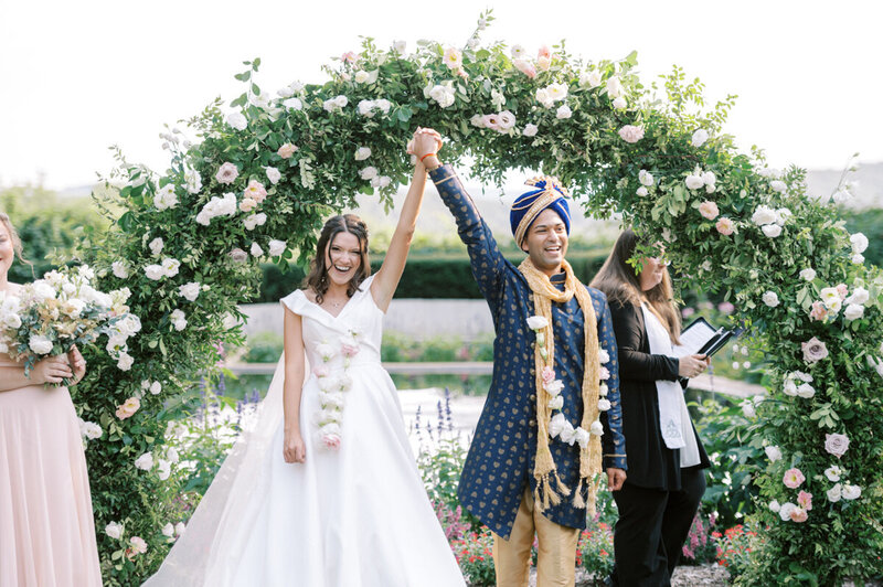A bride and a groom celebrating after their multicultural wedding ceremony at Box Hill Mansion
