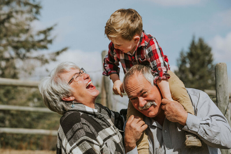 grandparents laughing with grandson