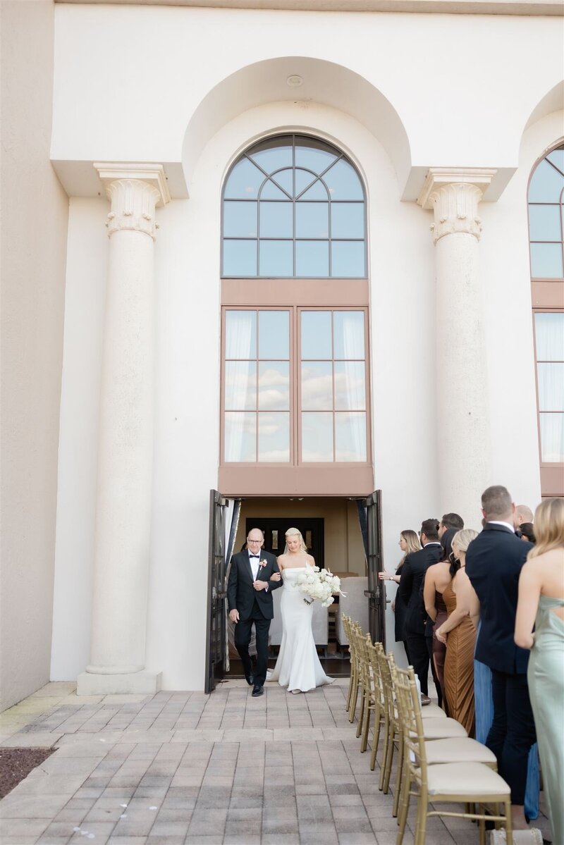 Bride walking down the aisle at the country club of Orlando.