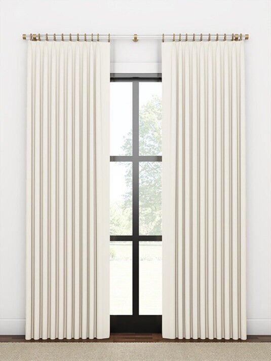 Double-width stationary drapery side panels framing a window