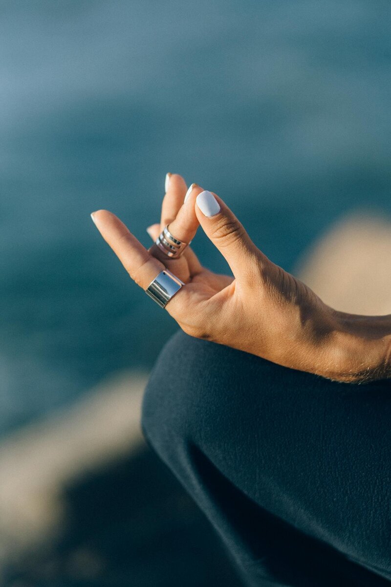 Close up of a woman's hand while she meditates.