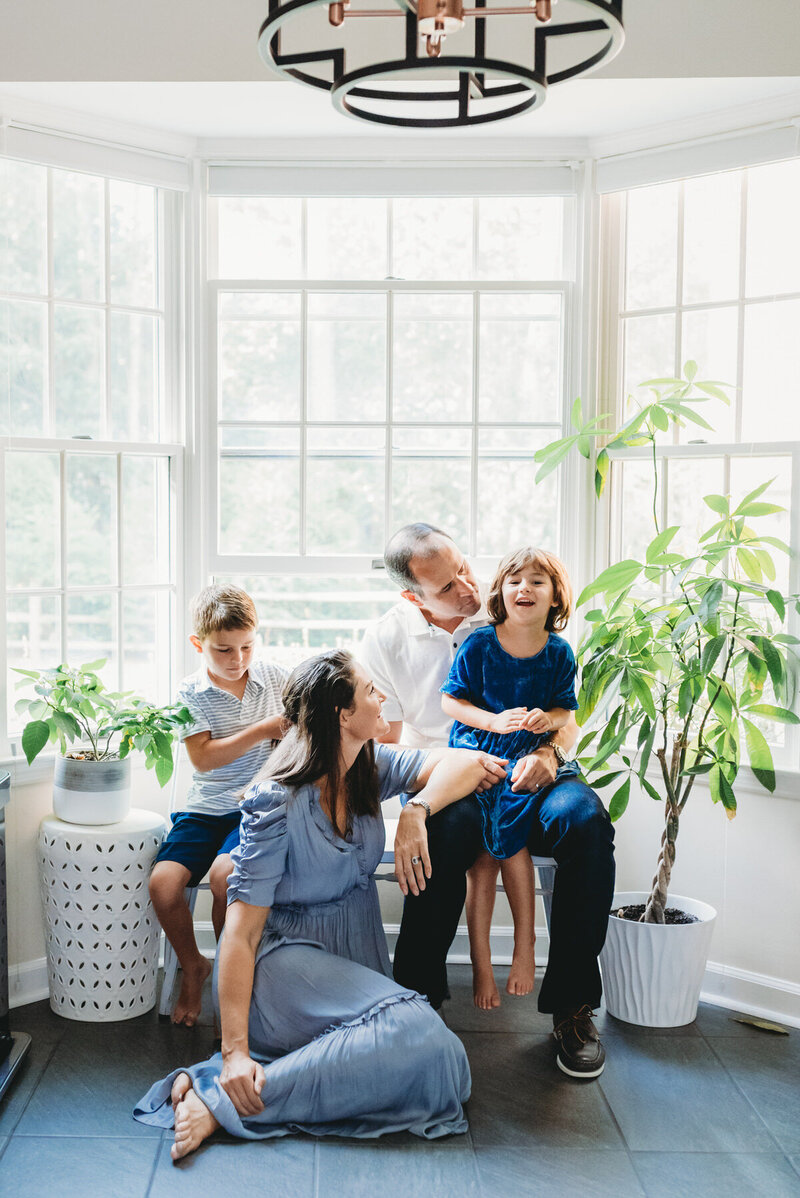 family sitting in front of window
