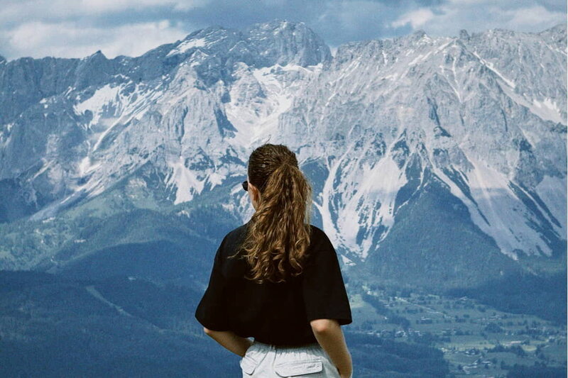 a woman looking at the mountains