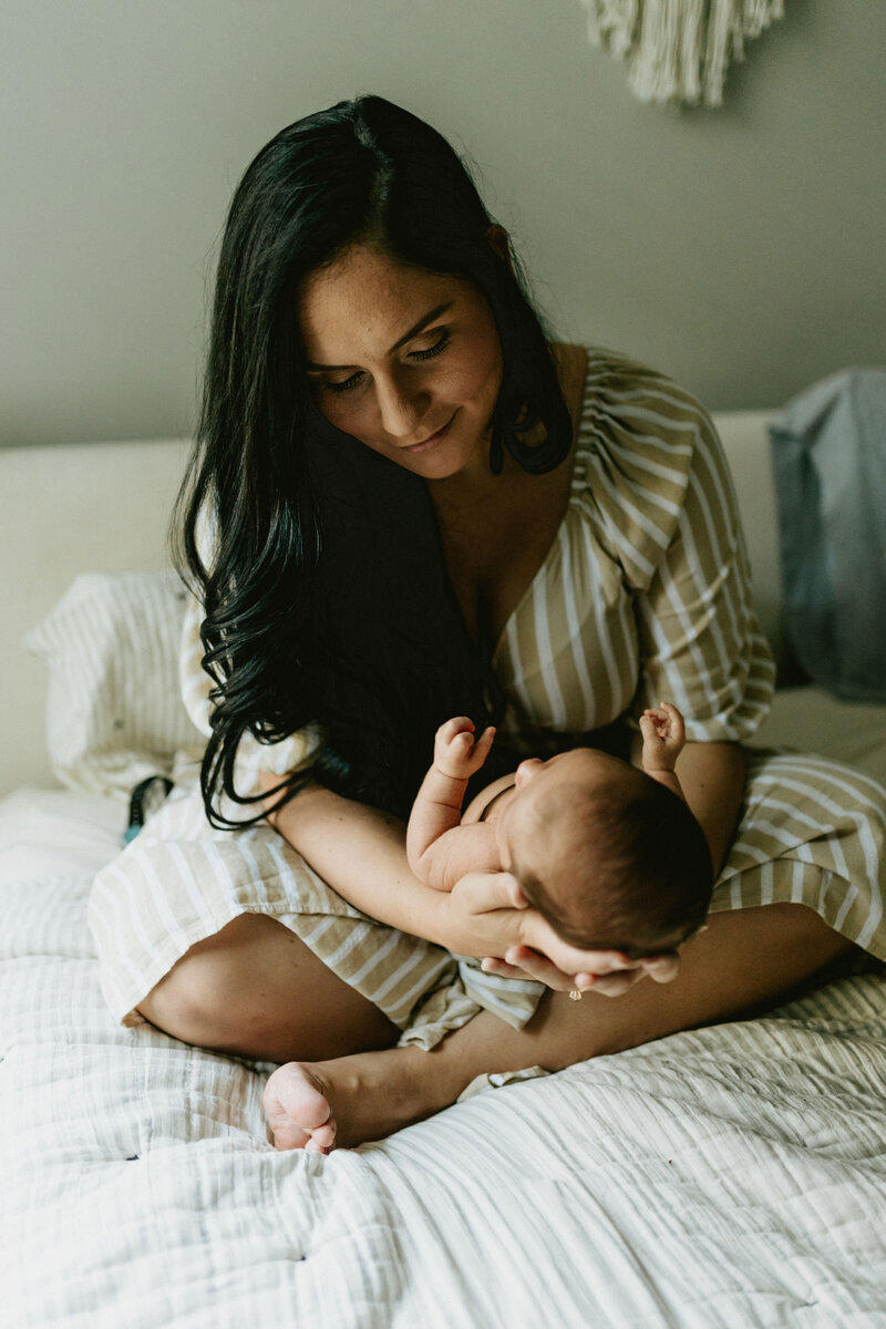 pregnant woman cradling her bare belly