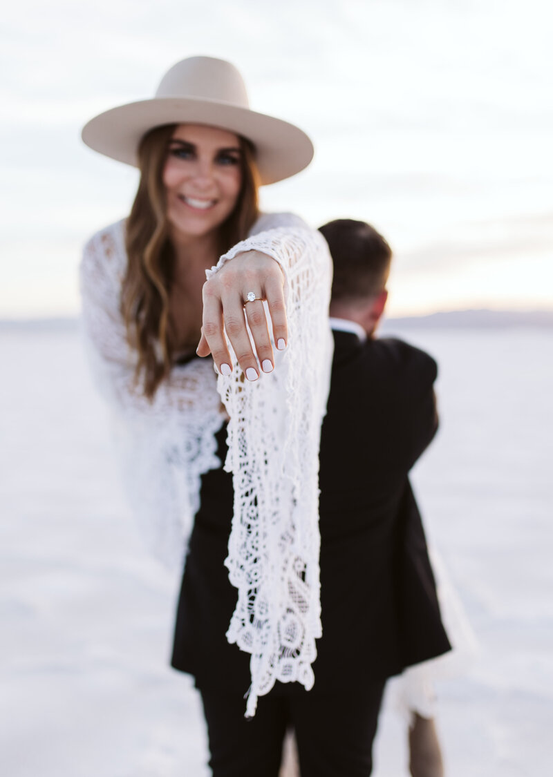 Close-up of a bride showing her engagement ring with a joyful smile during an Oregon Coast elopement.