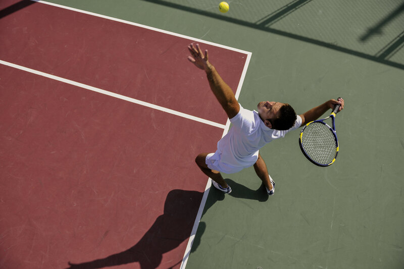 Overhead view of a tennis player serving the ball