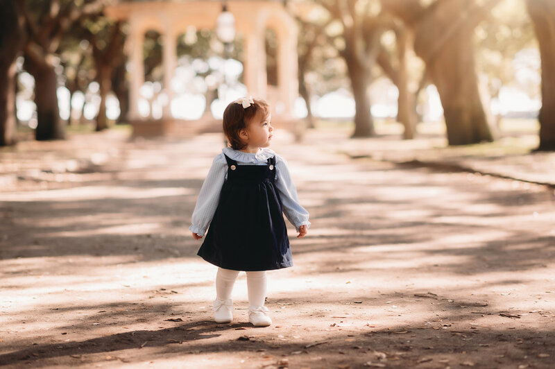 Toddler walks along a pathway in White Point Garden in downtown Charleston.