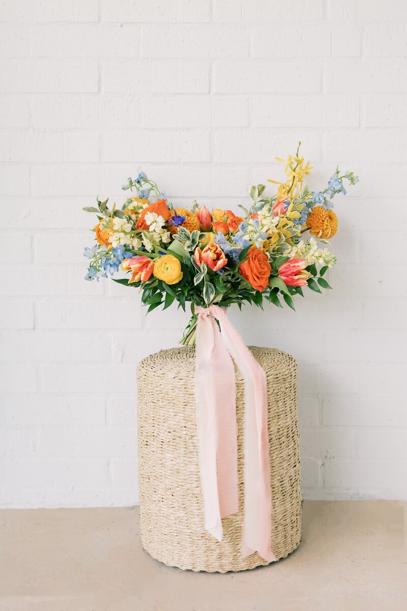 Close-up of an elegant wedding bouquet featuring colorful flowers and greenery.