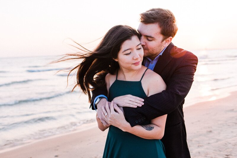 Bride and groom hugging at sunset beach elopement session in Washington beach
