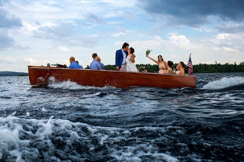 Squam Lake New Hampshire Wedding photo of a couple on a boat escaping a thunderstorm