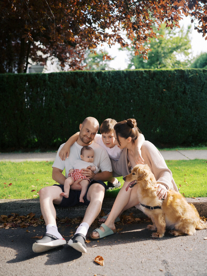 A family  of four hanging out together at Pitt Lake for family photos