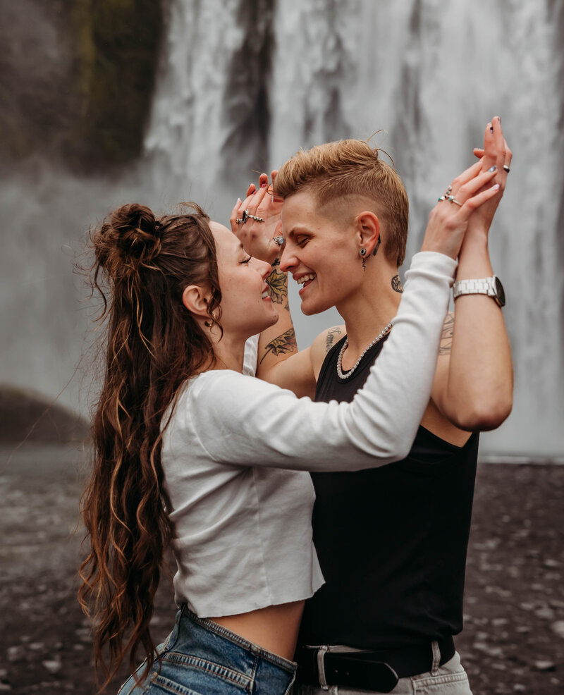 Romantic couples session at Skogafoss waterfall in Iceland.