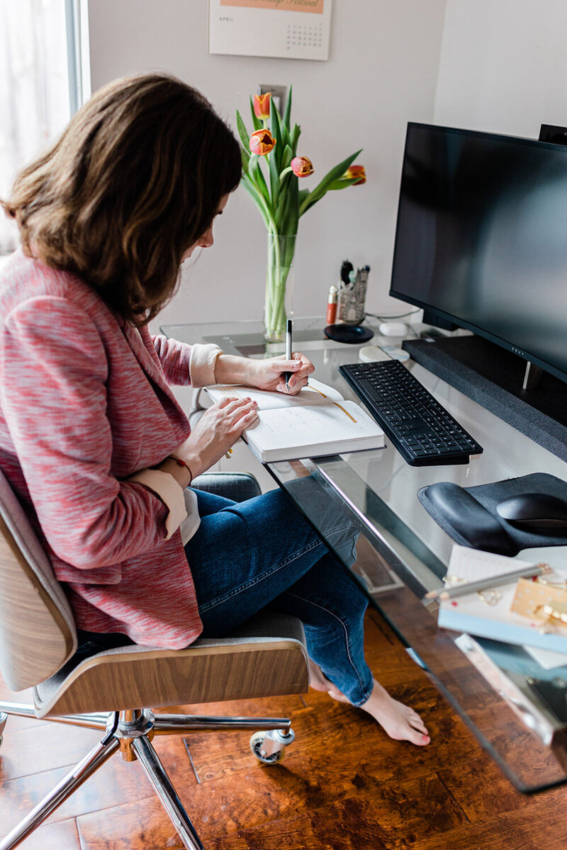 Andrea Shah's photo seating while working and writing something on her notebook