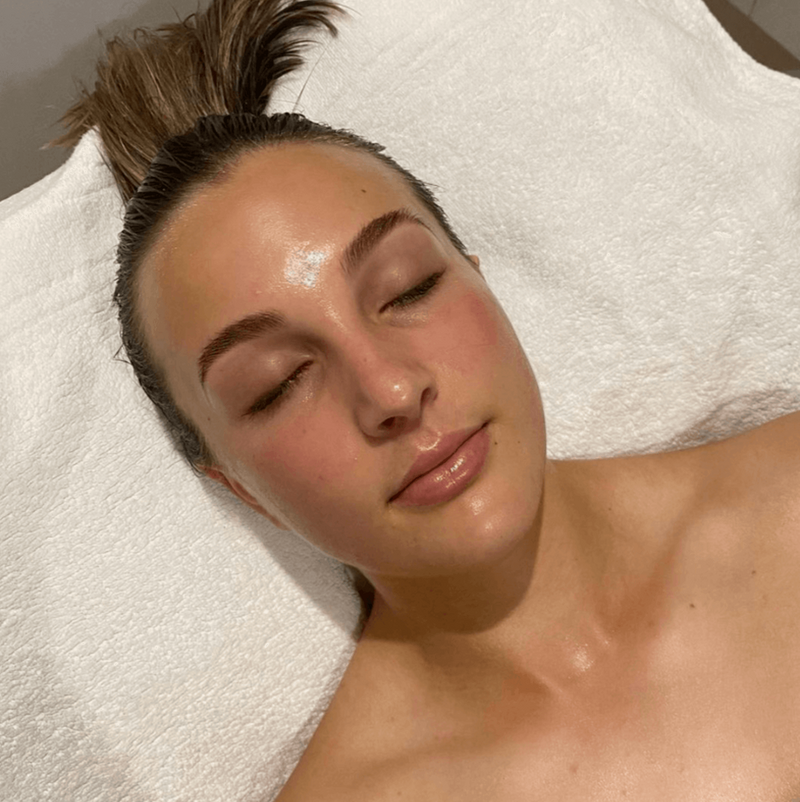 The middle of a dewy facial, eyes closed and hair up