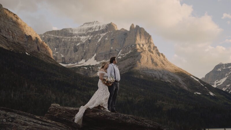 Bride and groom looking to the right while in the mountains