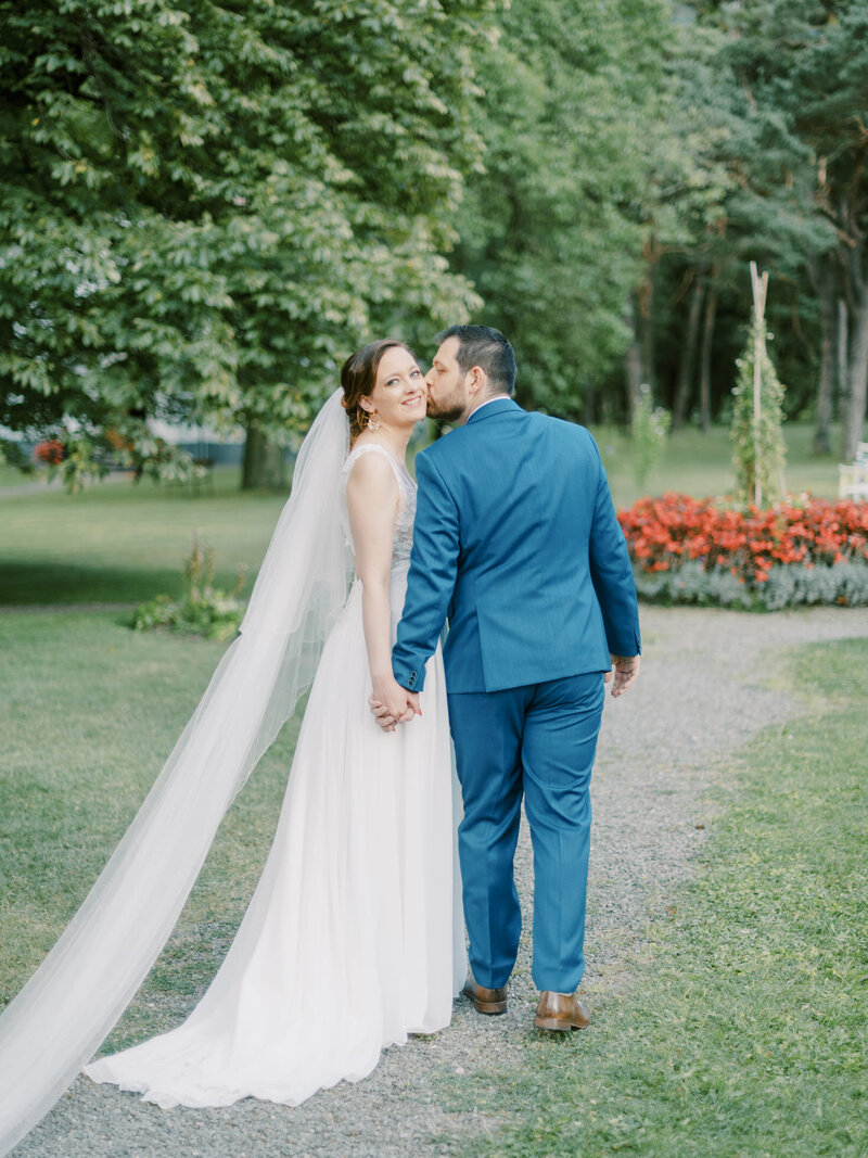 bride-and-groom-in-front-of-flower-arch