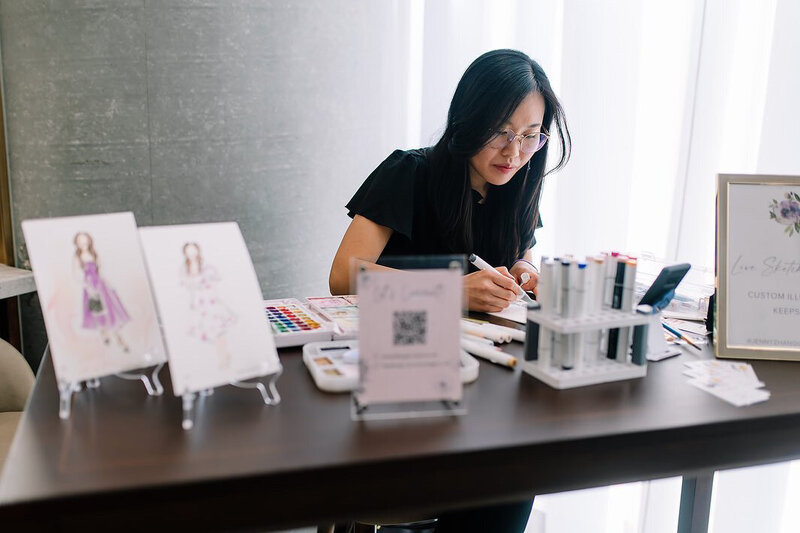 Toronto live event artist Jenny Zhang creating custom guest portraits at an event.