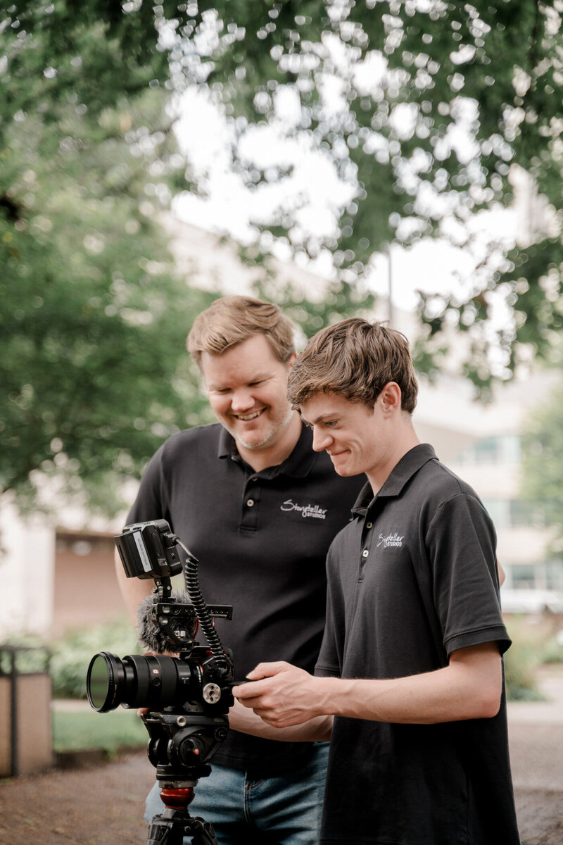 storyteller team members smiling and laughing on location in an historic neighborhood