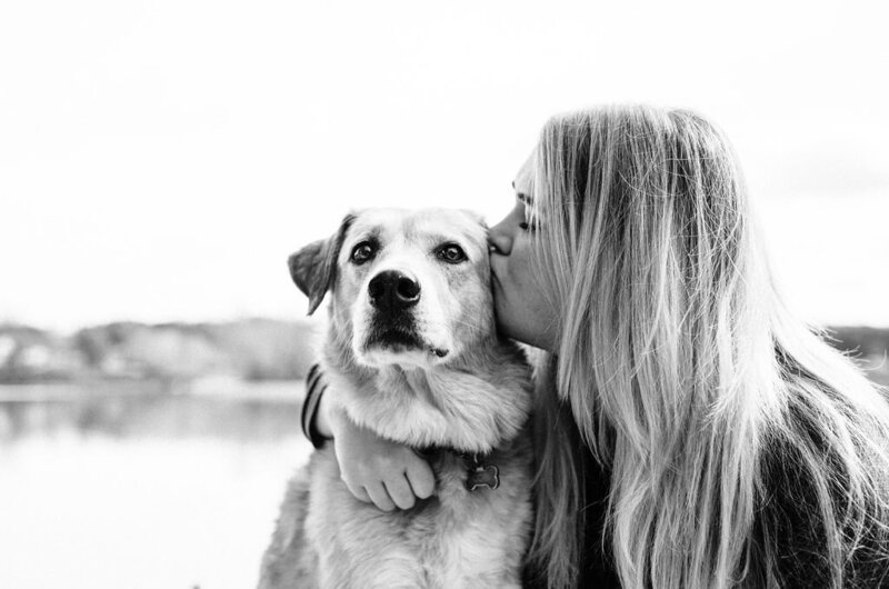 woman kissing her dog's face