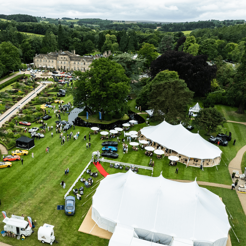 A small pole marquee with lots of ropes tying it down to the ground