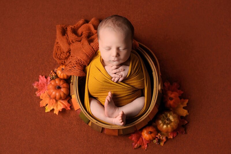 Fall themed orange and yellow newborn baby boy photoshoot in Burnaby