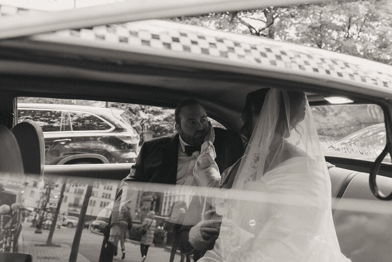 bride touching groom's face in taxi after eloping shot by Elsie Goodman Photography | NYC Elopement Packages