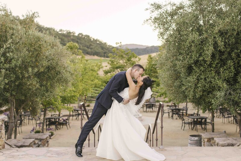 couple kissing in front of California trees