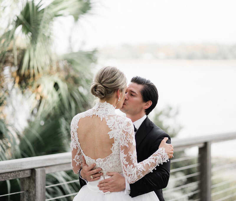 A groom wearing a black tux and bride wearing a beautiful white gown in Savannah during their wedding day