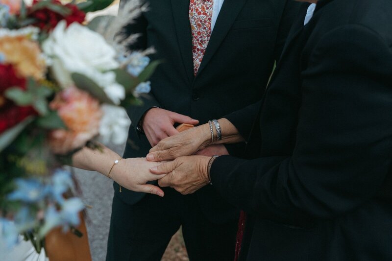 family holding the brides hand, captured by elsie goodman wedding photography