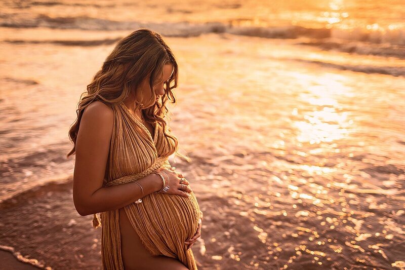 beautiful golden hue maternity portrait with woman wearing sand kasia kulenty gown
