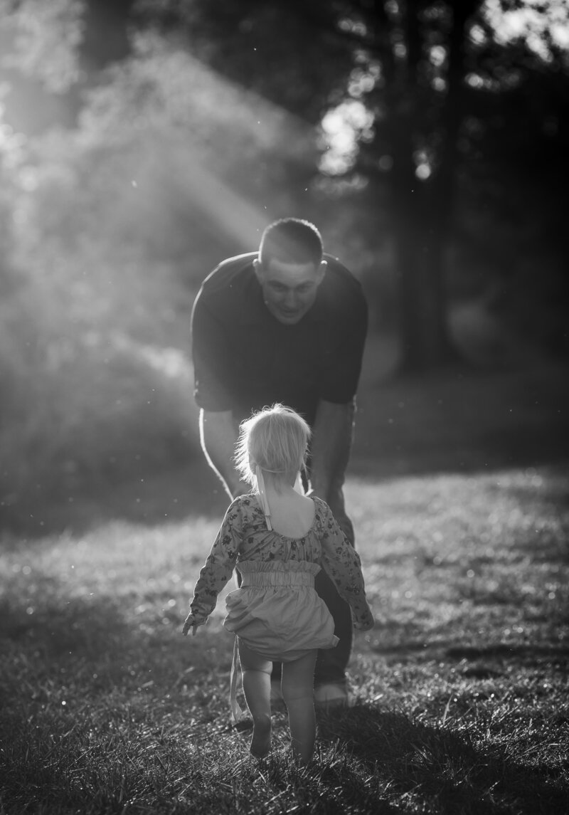 black and white photo, daughter is walking toward dad in Toledo