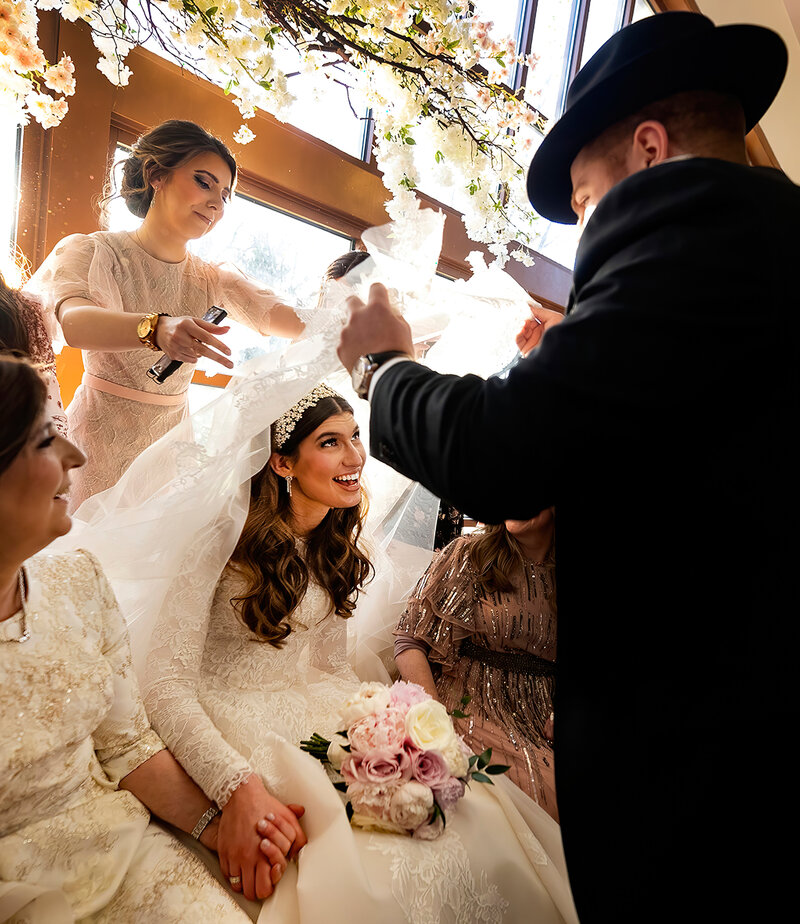 A father lifts the veil on his daughter during an orthodox Jewish wedding.