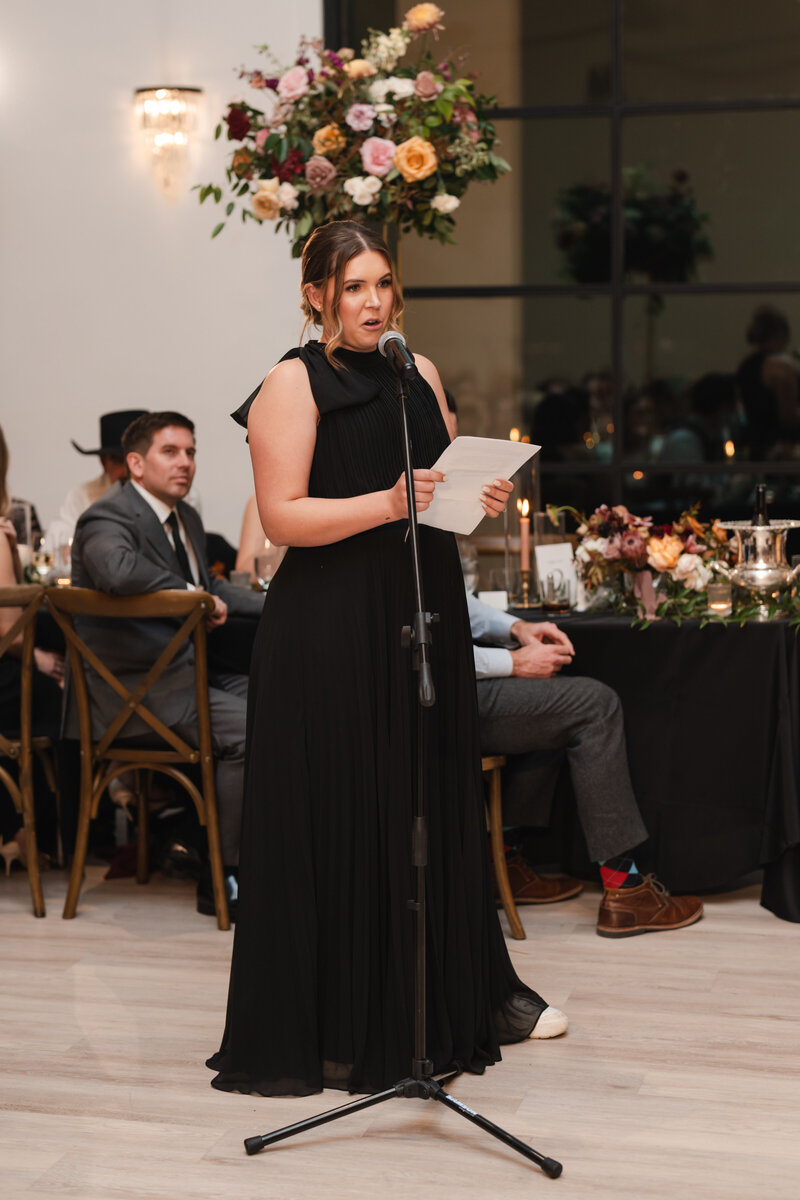 this long, black maid of honor dress looked beautiful during the wedding speech