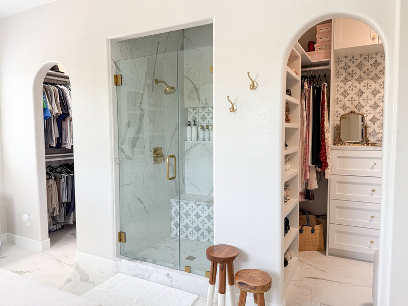 Main bathroom view of two closet archways  and shower 