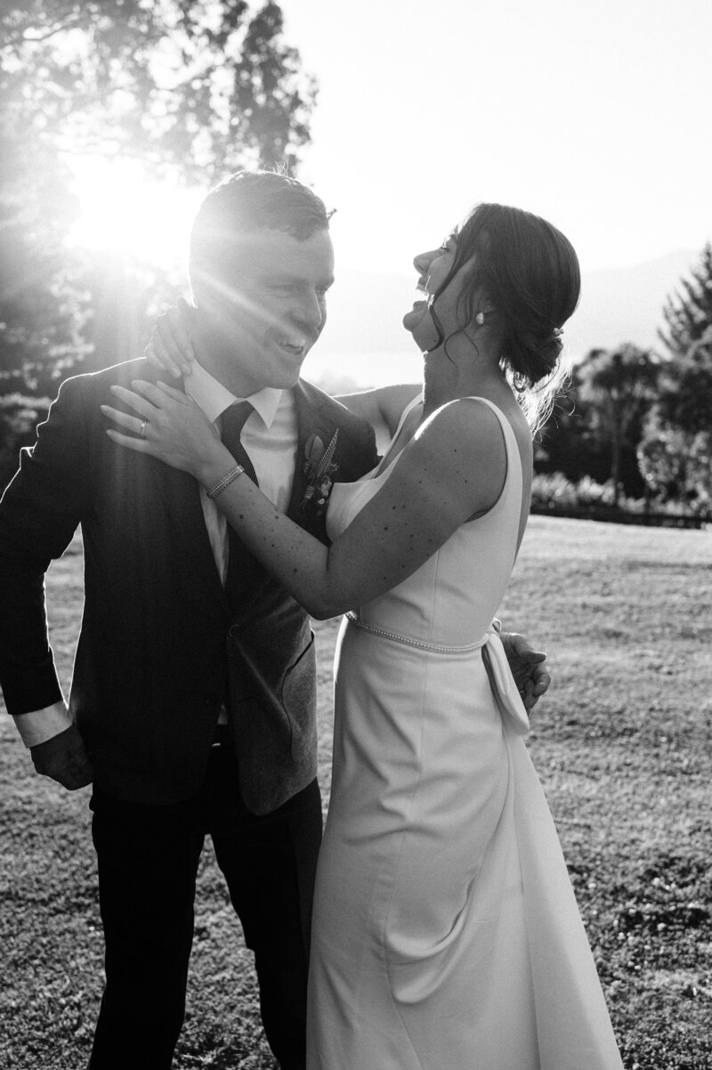 black and white shot of bride and groom at sunset at mt vernon in akaroa