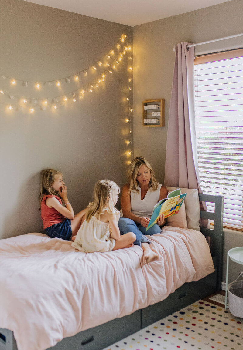 Brandy reading a book to daughters