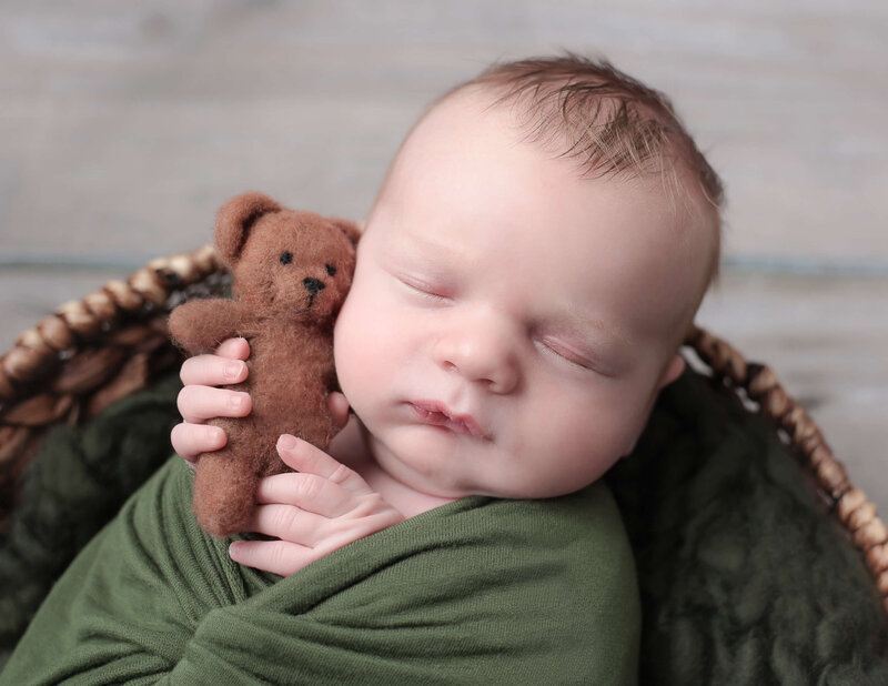 Baby boy holding a teddy bear in our Rochester, NY studio.