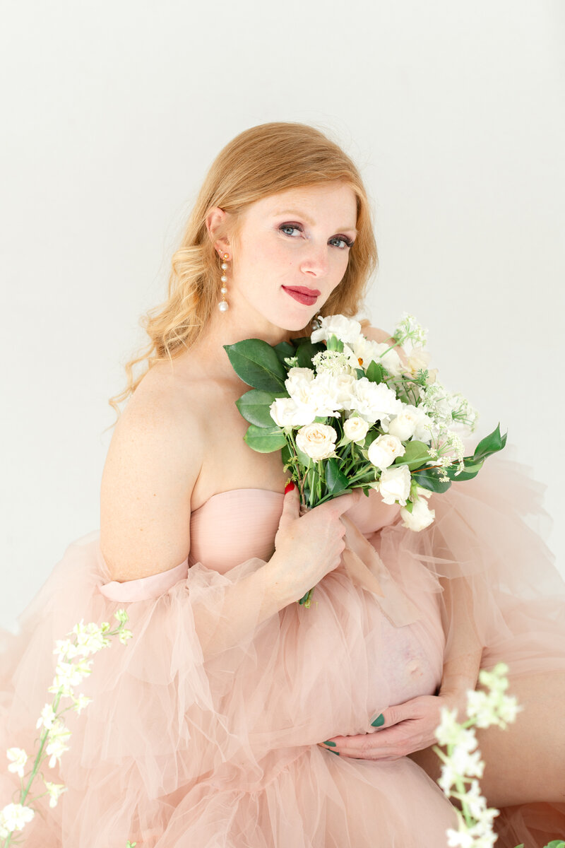 In-studio Maternity Session with floor floral arrangments for mother's day minis photoshoot