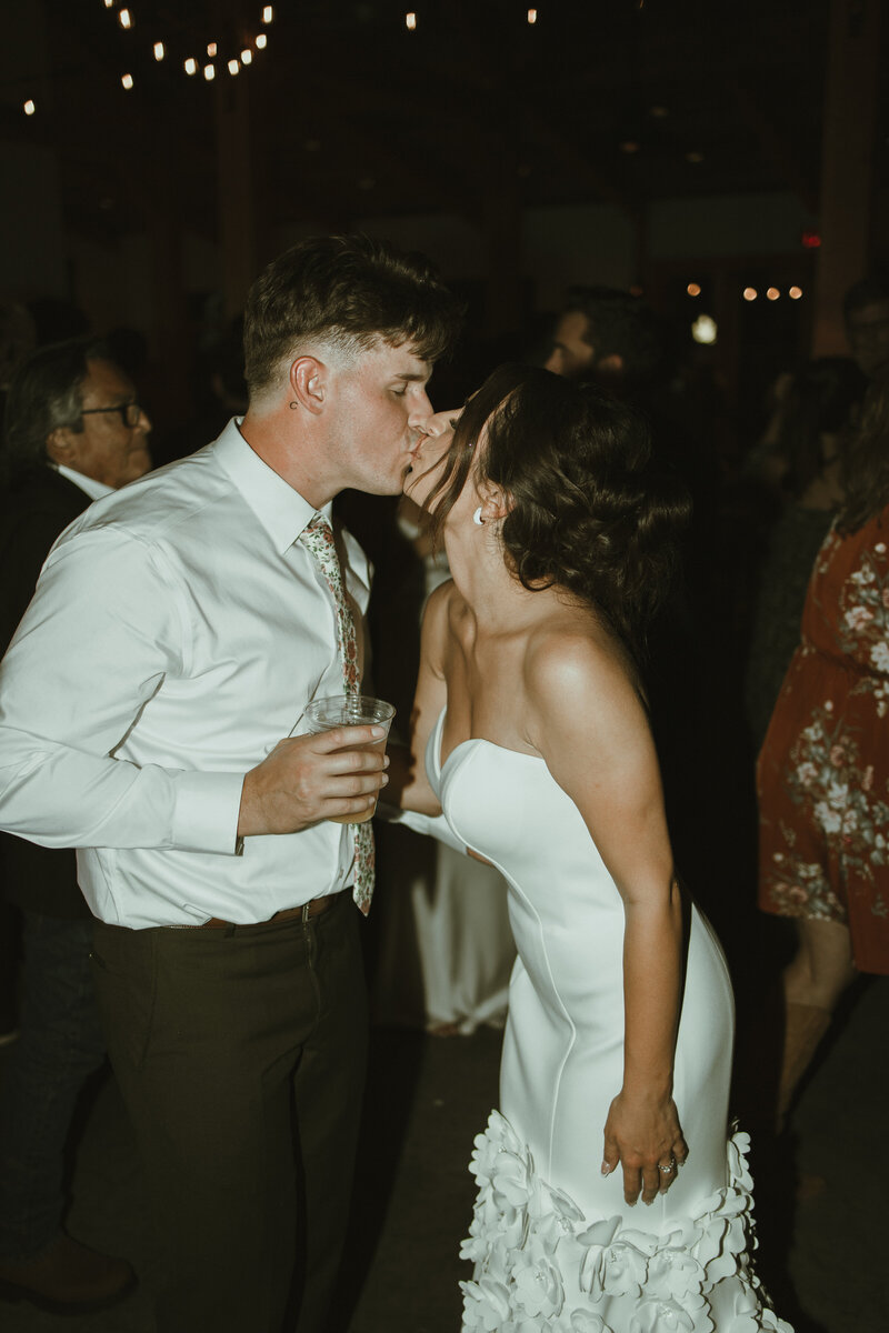 Bride and groom share a kiss on the dance floor