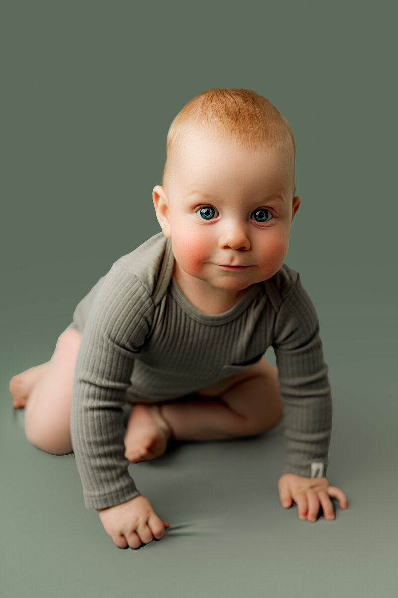 Toddler girl looking into camera while wearing pink dress