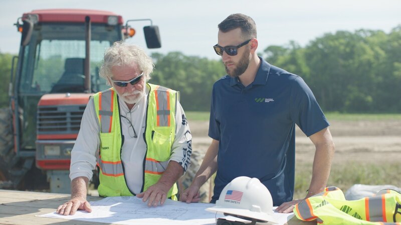Marty and team looking at blueprints