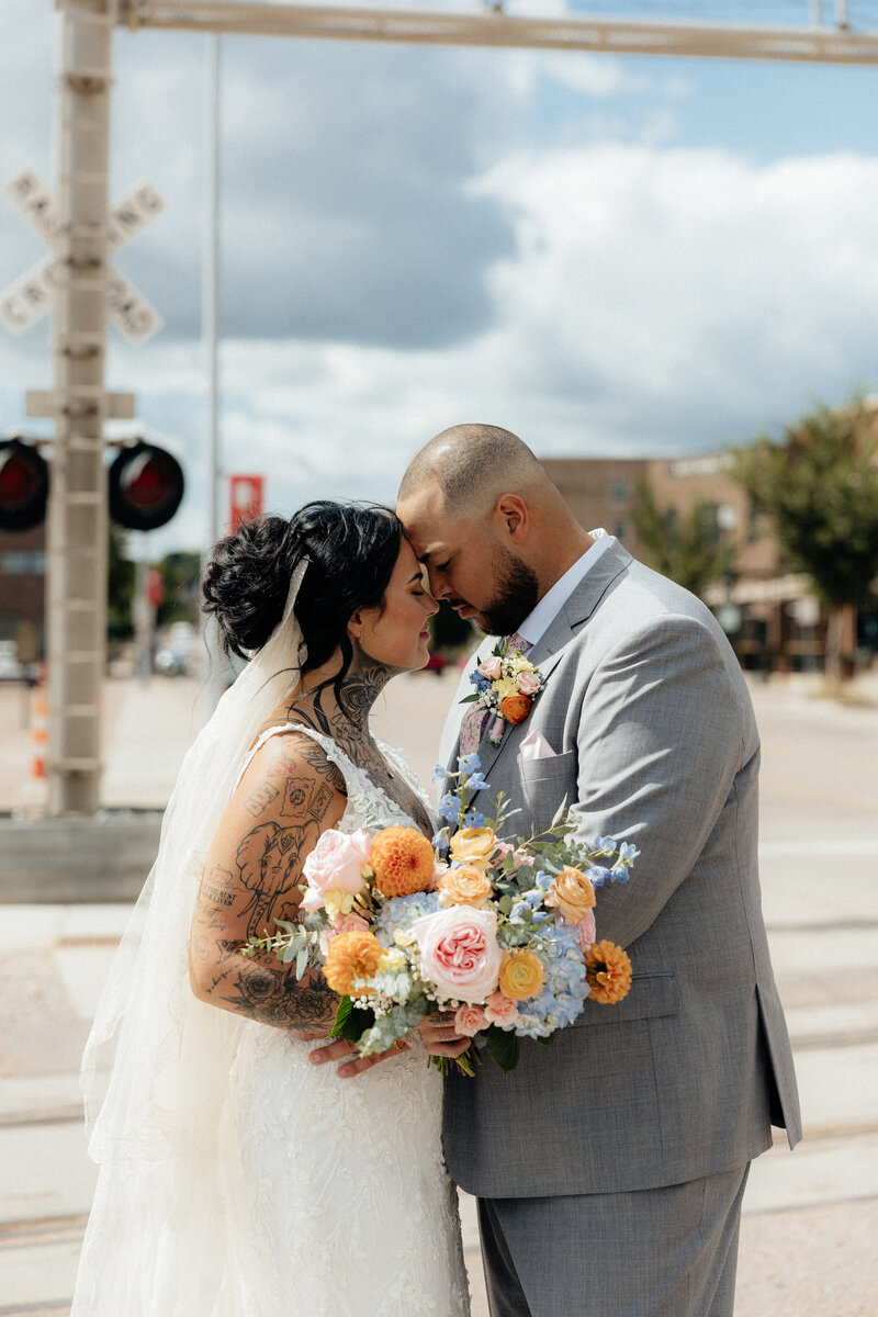 Dylan and Mollie standing forehead to forehead at Monick Yards.