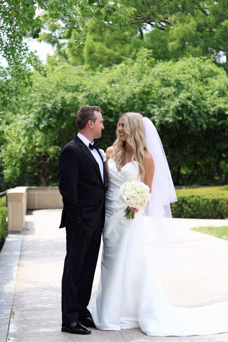 Bride and groom smiling at each other at Nelson Atkins Museum