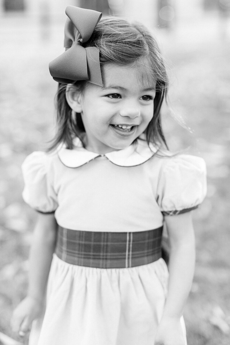 Child poses for family photos by Katelyn Ng Photography in Indianapolis, Indiana.