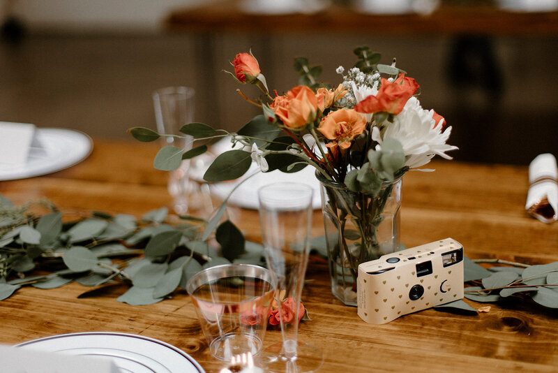 a vase of flowers being used as a table centerpiece