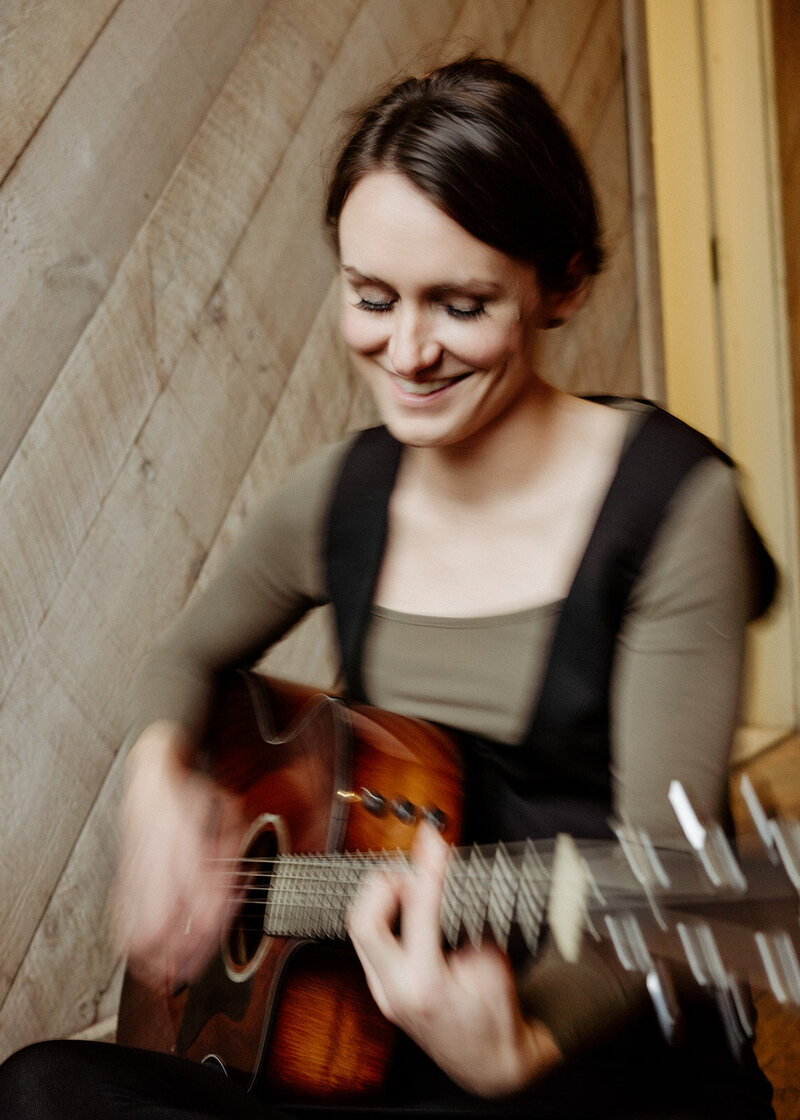 Professional headshot portrait and branding of a woman with a guitar by Sara McIngvale Photography